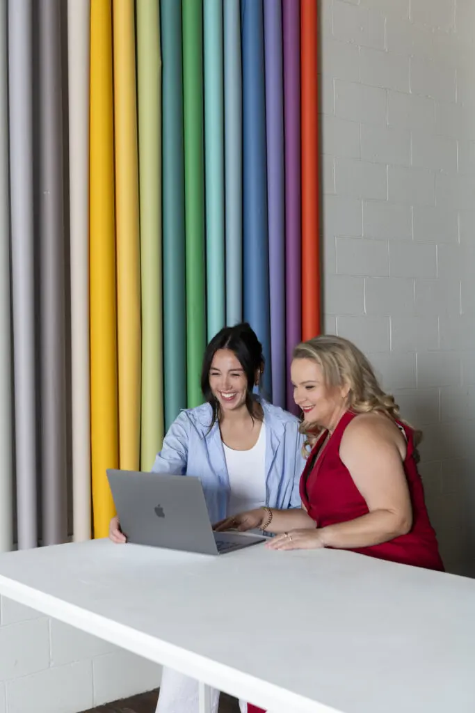 Juanita Wheeler working with a client at a laptop
