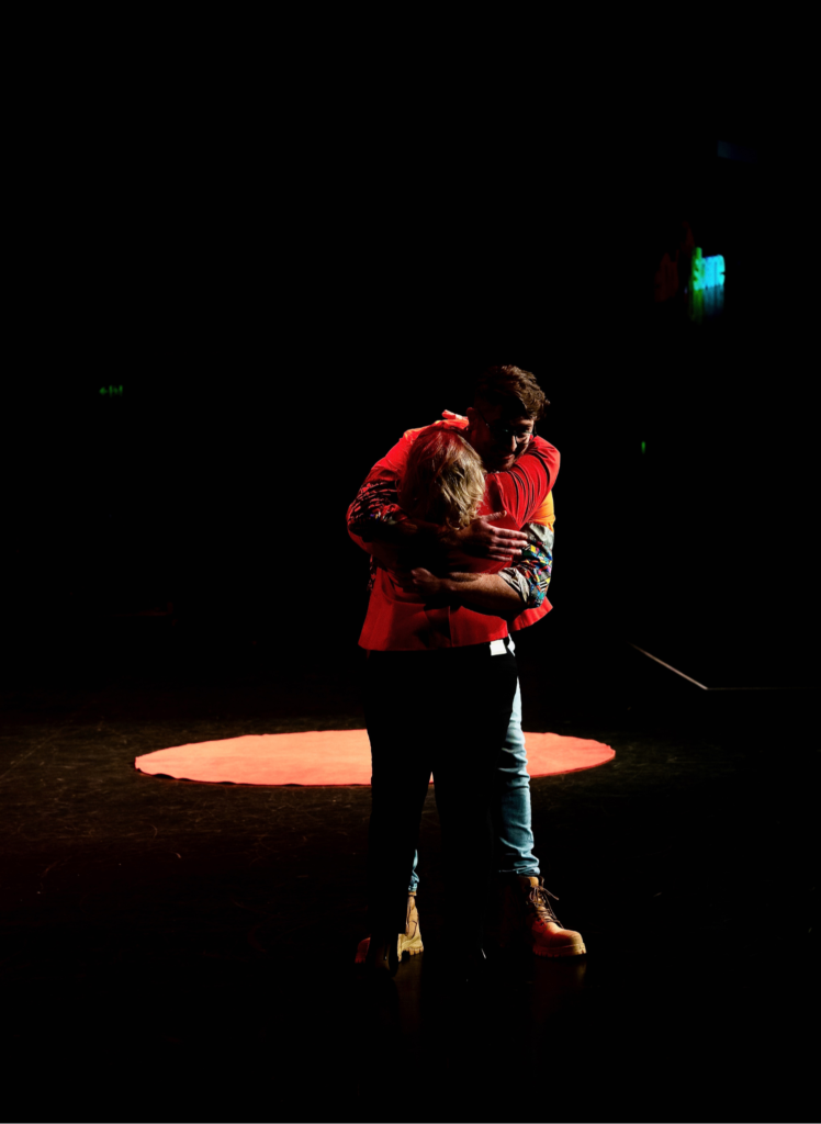 Dan Allen bends down - a long way - to hug Juanita as he leaves the stage after receiving a standing ovation from the audience.